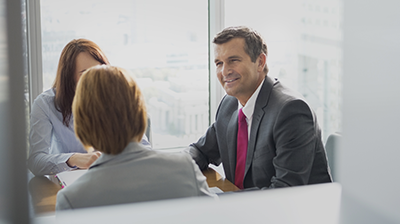 Top O’ Michigan Insurance Man talking to two women in business attire