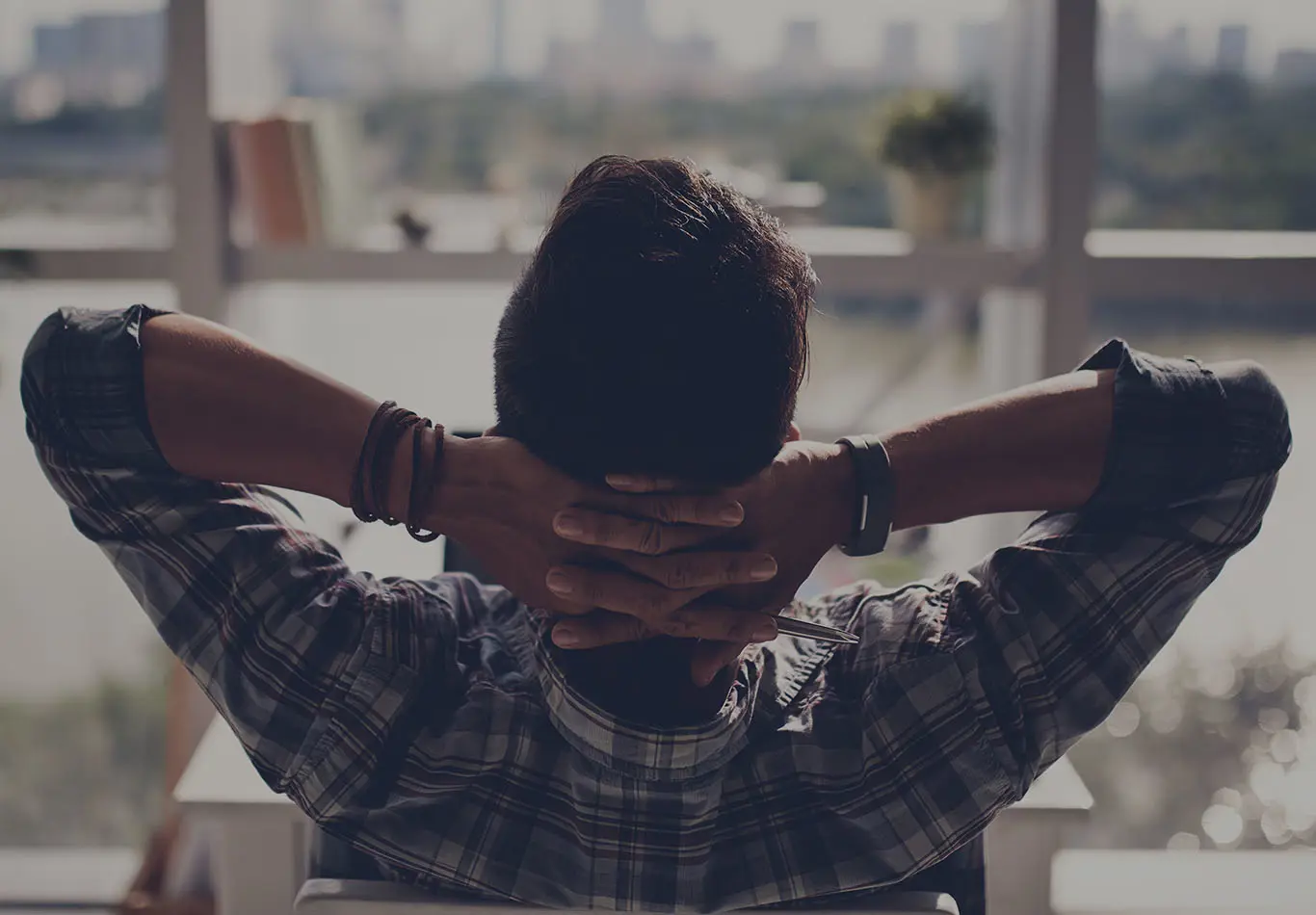 Bookroll Key Benefit 1 A man with his hands behind his back is looking out a windows