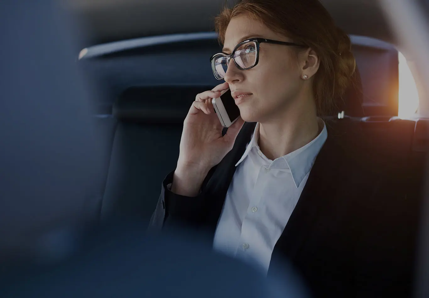 Inquiry Key Benefit 3 A woman is sitting in a car and talking on her phone