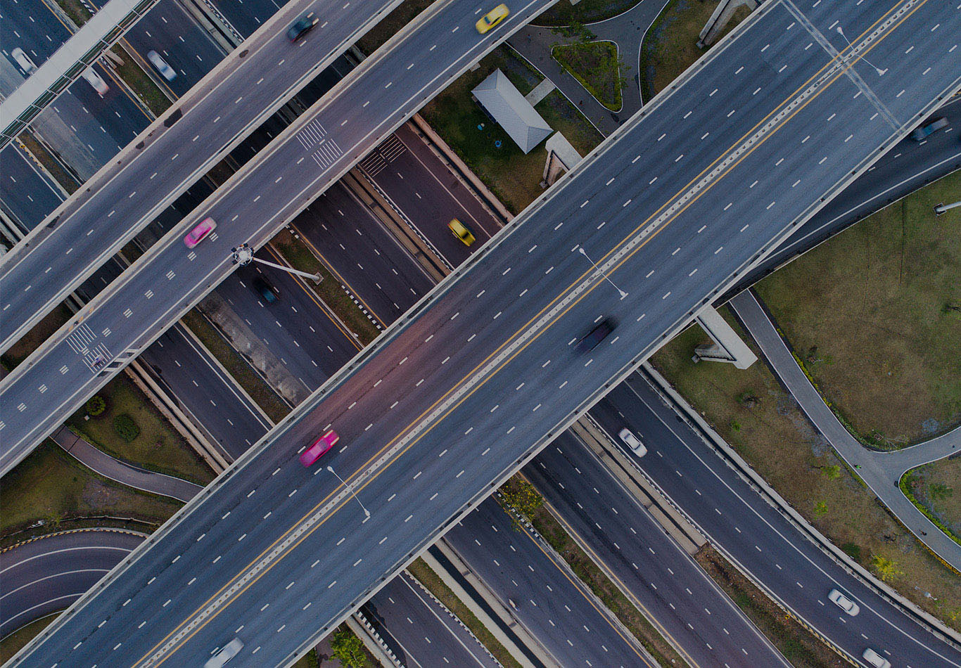 Aerial photo of a large intersection of roads on different levels. There are only a few cars on the roads.
