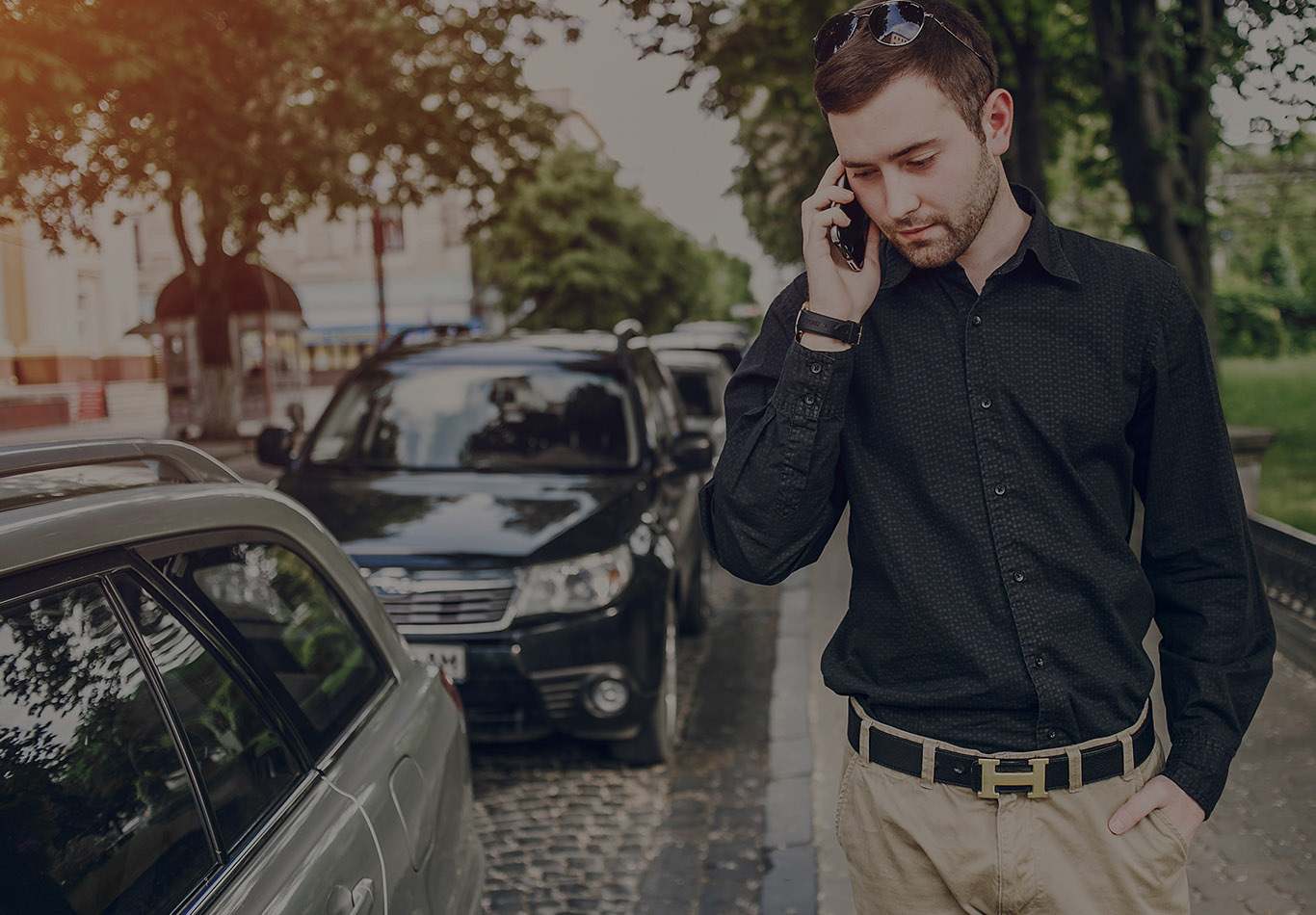 A man is walking down the street and talking on the phone