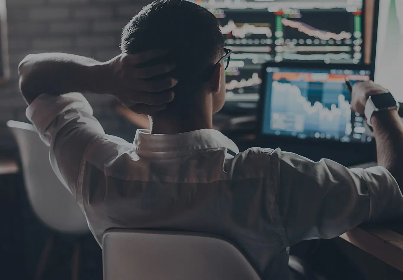 Rating Services Key Benefit 2 A business person is looking at a series of a monitors